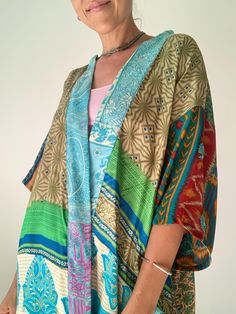 This is one of kind oryginal and stylish patchwork shirt, unisex oversized topper  true hippie boho style made of upcycled silk, flowy breathable and light perfect fun and party summer top, with wide kimono sleeves, made loose, funky colourful perfect for holidays,  easy to wear on its own or layered over fits all sizes S-XL chest meaesure 52" more available at  https://www.etsy.com/shop/AltheaStores? Thank you for looking Bohemian Patchwork Short Sleeve Tops, Bohemian Short Sleeve Patchwork Top, Casual Multicolor Patchwork Kimono, Hippie Patchwork Tops For Festival, Bohemian Short Sleeve Kimono One Size, Green Hippie Tops With Boho Print, Green Hippie Top With Boho Print, Green Boho Print Hippie Top, Hippie Green Top With Boho Print