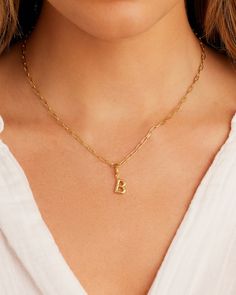 Description Personalize your favorite chain necklace with this playful helium alphabet charm. Wear your initials or a loved one's - you can make a set here. Product Details Total drop 11/16" Letter measures 5/16" by 3/8" Hinge closure measures 3/16" by 5/16" Available in 18k gold plated brass Avoid contact with anything containing derivatives of alcohol Everyday Yellow Gold Name Necklace, Dainty Initial Necklace With Charms, Personalized Dainty Initial Pendant Charms, Dainty Personalized Initial Pendant Charms, Initial Pendant Charms For Personalized Gift, Gold Initial Pendant Charms For Gift, Everyday Yellow Gold Initial Pendant Charm Necklace, 14k Gold Filled Initials Charm Necklace For Everyday, Everyday Gold Charms, Tarnish Resistant