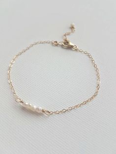 This delicate pearl bracelet looks so chic and stylish for every day wear or for a special occasion. Adorn yourself or bridesmaids in the natural, beautiful, luster of a fresh water pearl. Pick your preferred metal choice, with available options in sterling silver, 14k gold filled or 14k rose gold filled. The Details: - Featured: Four small fresh water pearls delicately hand wrapped using gold filled wire and adorned with delicate 14k gold filled cable chain.  - Contact us for custom bridesmaid Delicate Rose Gold Pearl Chain Bracelet, Feminine Pearl Charm Wedding Bracelets, Feminine Pearl Charm Bracelets For Wedding, Rose Gold Dainty Bracelets With Pearl Chain, Dainty Rose Gold Bracelets With Pearl Chain, Dainty Rose Gold Pearl Chain Bracelet, Elegant Wedding Pearl Chain Bracelet, Classic Pearl Charm Chain Bracelet For Wedding, Dainty Chain Bracelet For Wedding