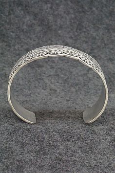 This stunning sterling silver bracelet was made by Navajo silversmith Leonard Maloney. The back is signed Maloney and stamped sterling.Size: 6" (will fit up to a 6 3/8" wrist)Gap: 1 3/8"Width: 1 3/4"Free shipping on all orders! We ship with USPS and always include tracking. All orders ship within a day of payment.Returns are accepted up to 30 days after you receive your order. Just send us a message. Our shop offers cash back or store credit. The item must be returned in new condition. Unique Adjustable Sterling Silver Bracelet With Intricate Design, Adjustable Sterling Silver Bracelet With Intricate Design, Adjustable Bohemian Sterling Silver Bracelet With Intricate Design, Unique Adjustable Etched Sterling Silver Bracelet, Unique Etched Adjustable Sterling Silver Bracelet, Traditional Sterling Silver Nickel-free Bracelet, Traditional Nickel-free Sterling Silver Bracelet, Unique Adjustable Engraved Sterling Silver Bracelet, Bohemian Sterling Silver Bracelet With Oxidized Finish