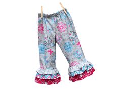 a child's pants with ruffles and flowers on it