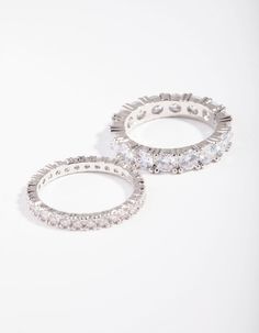 two white gold and diamond hoop earrings, one with round brilliant cut diamonds on each side