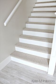 the stairs are painted white and have chevroned carpet