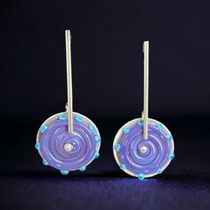 pair of purple and blue earrings on black background