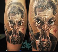 a man's leg with tattoos on it that has an image of two faces