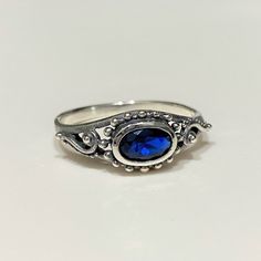 Sterling Silver Blue Sapphire Filigree Ring...Marked 925...Total of weights 1.8gramsMeasure of face 7MMMM...It's in very good condition. Blue Silver Ring, Silver Alexandrite Engagement Ring, Silver And Blue Ring, Blue Oval Sterling Silver Birthstone Ring, Blue Oval Birthstone Ring In Sterling Silver, Blue Crystal Sterling Silver Ring Stamped 925, Blue Sterling Silver Crystal Ring, Stamped 925, Blue Sterling Silver Stackable Rings With Gemstones, Blue Gemstone Stackable Rings In Sterling Silver