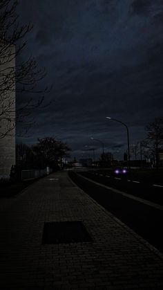 a dark street at night with the lights on