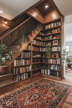 a bookshelf filled with lots of books next to a stair case