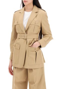 Find MAX MARA Pacos Canvas Saharan Jacket For on Editorialist. This Sahariana jacket from the Max Mara Runway collection is made of pure cotton canvas. It features a single-breasted construction with front patch pockets and flaps. The jacket has a notched collar, shoulder epaulettes, and buttoned cuffs with pleats. It cinches at the waist with a matching belt and buckle, finished with side slits on the back. The tailored cut is enhanced by padded shoulders. The model is 177 cm tall and wears an IT size Beige Utility Jacket With Cargo Pockets For Work, Designer Beige Cotton Outerwear, Gabardine Utility Jacket With Pockets For Work, Workwear Gabardine Utility Jacket With Pockets, Workwear Utility Jacket With Pockets In Gabardine, Beige Workwear Outerwear With Multiple Pockets, Beige Outerwear With Multiple Pockets For Work, Designer Cotton Outerwear With Pockets, Belted Beige Cotton Outerwear