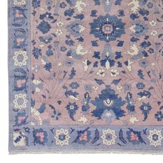 an antique rug with blue and pink flowers