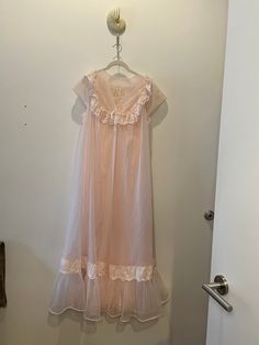 "Estate sale find. Beautiful Vintage MCM 1960's-1970's  Shadowline Peignoir Set | |Nightgown & Robe Ensemble Peachy Pink. In nylon/chiffon.  Perfect honeymoon nightgown and collectors item. Tag size is Medium.  Please review pixs, video, and measurements below.  All sales final. 20\" PTP 53\" STH *This is a vintage item which has history and was pre-loved. All major flaws are listed. **I do not accept returns unless the item was misrepresented. Please message me first and ask questions! I want t Vintage Sheer Sleepwear For Evening, Feminine Sheer Gown, Vintage Dresses For Wedding Night, Vintage Nightgown For Spring Party, Vintage Sheer Nightgown For Wedding Night, Vintage Sheer Lace Nightgown, Vintage Sheer Sleepwear, Vintage Sheer Lace Sleepwear, Vintage Lace Sleepwear For Spring