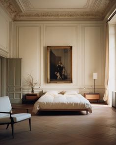 a bedroom with a large painting on the wall