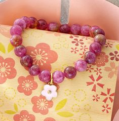 Watermelon beads are symbol of wealth, prosperity and fecundity because of its many seeds. This beautiful bracelet comes with a pink daisy charm. 8mm beads, 7 inch length, elastic fit Watermelon Bracelet, Watermelon Beads, Blossom Bracelet, Daisy Charm, 8mm Beads, Pink Daisy, Plum Blossom, Honolulu, Bead Bracelet