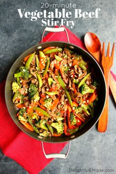 a skillet filled with vegetables and meat on top of a red towel