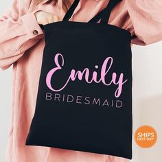 a woman is holding a black bag with pink lettering that says,'enjoy bridesmaid '