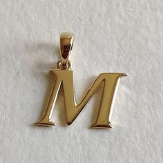 This is an exquisite initial charm pendant set in 14K Solid Gold.  An elegant design, perfect for any occassion. ITEM DETAILS: ✓ Letter : M ✓ Gold Kt: Solid 14K Yellow Gold ✓ 14 K Gold Weight : 1.51 grams ✓ Gross Weight: 1.51 grams >>The Gold purity is guaranteed and it comes with authentic 14K gold hallmark. >>A-Z letters available on my Etsy Shop. CUSTOMER SUPPORT: We are available 24/7 to respond to all your queries! PACKAGING: The pendant comes in layers of safe and secure wrapping along with a free Handmade Jewelry Box. Classic Formal Initial Necklace, Classic Initial Pendant Jewelry With Hallmarks, Anniversary Initial Pendant Necklace With Polished Finish, Classic Yellow Gold Initial Necklace For Mother's Day, Classic Yellow Gold Initial Necklace For Anniversary, Mother's Day Yellow Gold Classic Initial Necklace, Mother's Day Classic Yellow Gold Initial Necklace, Classic Pendant Initial Necklace, Formal Hallmarked Initial Pendant Necklace