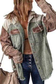 a woman with long hair wearing a jacket and jeans holding a handbag in her right hand