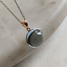 ITEM DESCRIPTION: >>The pendant is made from Solid 14K Yellow Gold. Gemstone used is absolutely natural and ethically sourced. >>Natural Sky Blue Topaz in cabachon and r0und shape with bezel setting is studded on it with utmost precision. >>This is a minimalist design and is absolutely hassle-free and everyday jewelry. Gem: Sky Blue Toapz Gem size: 13x13 mm round Gem weight: 13.10 carats Gold purity: 14K (58.33% approx.) Gold weight: 0.55 grams Gross weight: 3.17 grams The Gold purity is guarant Formal Cabochon Blue Topaz Jewelry, Blue Topaz Round Pendant For Formal Occasions, Gold Blue Topaz Jewelry With Polished Finish, Formal Blue Topaz Round Pendant Jewelry, Round Yellow Gold Blue Topaz Gemstones, Yellow Gold Blue Topaz Round Pendant, Green Amethyst Birthstone Jewelry For Anniversary, Classic Round Green Amethyst Jewelry, Anniversary Blue Topaz Round Necklace