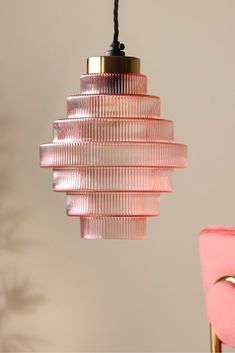 a pink lamp hanging from a ceiling in a room