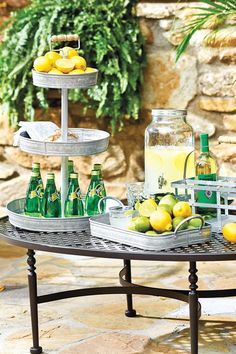 a table with lemons, limes and bottles on it