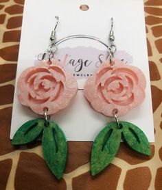 This listing is for a Pink Rose Resin earrings with a leaf dangling. Ear wire closure. Pink Dangle Jewelry With Rose Design, Pink Rose Design Dangle Jewelry, Pink Rose Design Drop Earrings, Pink Rose Design Dangle Earrings, Handmade Rose Dangle Earrings, Handmade Rose Drop Earrings, Rose Drop Earrings With Rose Design, Rose Color Flower Drop Earrings, Resin Earring