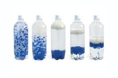 four bottles with blue and white bubbles in them on a white background, one is empty