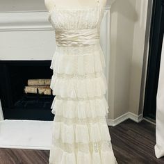 This Is A Beautiful Dress That I Wore Just One Time For My Wedding. I Had It Dry Cleaned So It Is Clean And In Perfect Condition! It Has Spaghetti Straps And An Empire Waist With A Long Satin Ribbon That Can Be Tied In The Back Or Wrapped Around The Waist And Tied In The Front. I Am 5’9” Wearing Flat Shoes. Tiered Lace Bodice Wedding Dress, Tiered Wedding Dress With Lace Bodice, Elegant Gown With Spaghetti Straps And Ruffles, Sweetheart Neckline Maxi Dress With Ruffles For Wedding, Lace Maxi Dress With Spaghetti Straps For Wedding, Wedding Maxi Dress With Sweetheart Neckline And Ruffles, Elegant Ruffled Maxi Dress For Beach Wedding, Elegant Gown For Beach Wedding With Fitted Bodice, White Tiered Wedding Dress