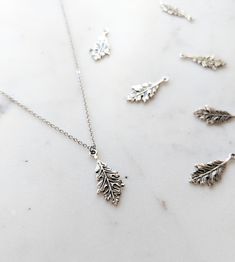 This is a dainty solid sterling silver oak leaf pendant on a hypoallergenic stainless steel fine chain. The detail on this leaf is incredible, with each vein being visible. This necklace can be showered in but I recommend it be taken off during sleeping due to the fine nature of the chain. Many chain lengths available🌲 Thank you so much for checking out my shop!🧡 Personalized Silver Nature-inspired Jewelry, Sterling Silver Leaf-shaped Jewelry Gift, Nature-inspired Silver Jewelry With Adjustable Chain, Minimalist Leaf-shaped Sterling Silver Jewelry, Silver Nature-inspired Necklace For Everyday, Minimalist Sterling Silver Leaf Jewelry, Everyday Silver Necklace With Nature-inspired Style, Everyday Silver Nature-inspired Necklace, Everyday Nature-inspired Silver Necklace