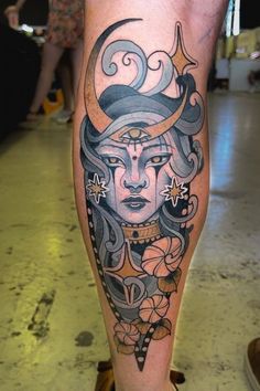 a woman's leg with an artistic tattoo design on the legs and her face