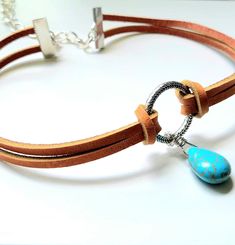 A de Ava handmade  jewelry on Etsy offers quality leather bracelets, leather necklaces and custom designed pieces. ✄Specifics on This Piece: Genuine tan latigo leather Silver colored center ring Turquoise colored teardrop charm Lobster clasp Necklace is approximately 13 inches with additional chain for extended sizes ✄If you're sending this item directly to someone as a gift and would like me to include a note to the recipient, I'm happy to do this for you! Please leave a Note to Seller when placing your order. Keep shopping! Browse my shop to see other unique pieces I offer: www.etsy.com/shop/AdeAvA Festival Leather Jewelry With Adjustable Cord, Handmade Artisan Jewelry With Waxed Cord, Artisan Handmade Jewelry With Waxed Cord, Unique Adjustable Turquoise Choker, Bohemian Turquoise Jewelry On Waxed Cord, Bohemian Turquoise Jewelry With Waxed Cord, Bohemian Jewelry In Turquoise Waxed Cord, Bohemian Jewelry In Turquoise With Waxed Cord, Bohemian Adjustable Sterling Silver Choker