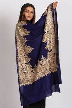 Our Priya Embroidered Shawl features fine embroidery on soft 100% merino wool. Specialty piece.This classically beautiful shawl showcases the intricate embroidery traditions of Northern India with stunning embroidery in metallic tones on a black base. Suitable for a black tie event, evening out, dinner party. Can change the look of last year's dress or pantsuit. A formal living room, drape over the back of the couch. The high quality and elegance of our embroidered shawls make them treasures tha Embroidered Pashmina Shawl, Elegant Pashmina Shawl With Intricate Embroidery For Festive Occasions, Elegant Jamawar Shawl With Embroidered Border, Elegant Pashmina Shawl With Intricate Embroidery For Festivals, Elegant Unstitched Embroidered Shawl Fabric, Pashmina Scarves With Intricate Embroidery In Traditional Drape, Festive Winter Dupatta With Embroidered Border, Festive Jamawar Scarves With Intricate Embroidery, Elegant Pashmina Dupatta With Intricate Embroidery