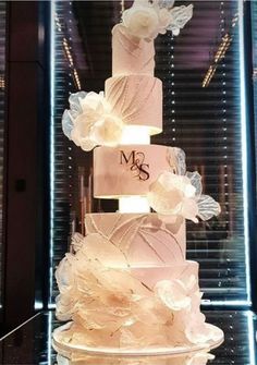 a three tiered wedding cake with flowers on it