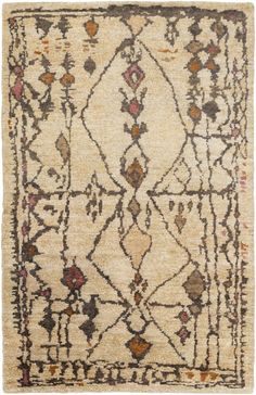 an old rug with many different colors and patterns on the carpet, including brown, beige,