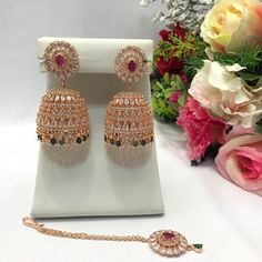 "CZ American Dimonds Jhumka Earrings With Tika High Quality Heavy Rose Gold Plated Cubic Zirconia Indian Jewelry Set Bollywood jewelry  Earrings Length: 2.1\"inches approx  Earrings Width: 1.1\" Inch Approx  It is a perfect match with formal attire on special occasions or with casual wearing The item will come with the clear plastic box or plastic bag and packaging Traditional Indian Wedding Jewellery Slight Colour variations possible due to difference in screen and photograph Care instructions Keep Jewellery away from direct heat, water, perfumes, deodorants and other strong chemicals as they may react with the metal or plating. The plating composition of Jewellery is as such that perspiration (sweat) will not damage it. Wipe Jewellery gently with chamois cloth or leather swatch after eve Traditional Rose Gold Jewelry Sets For Festive Occasions, Traditional Rose Gold Jewelry Sets For Festivities, Traditional Rose Gold Jewelry Sets Hand Set, Traditional Rose Gold Hand Set Jewelry Sets, Cubic Zirconia Jhumkas For Gift, Hand Set Cubic Zirconia Jhumkas Gift, Rose Gold Danglers For Wedding, Gold Bollywood Jhumkas With Cubic Zirconia, American Diamond Jhumkas With Latkans For Gift