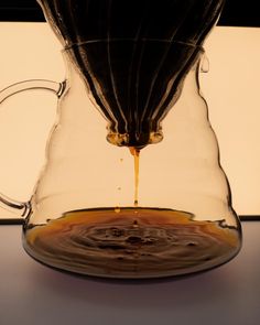 a pitcher filled with liquid sitting on top of a table