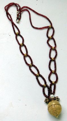 "An exclusive beautiful tribal pendant necklace from Rajasthan northern India. We sourced this piece of gem from a well known tribal family on the outskirts of Jodhpur. Solid well made 22 karat Gold sphere , the bottom half has tiny granulation ending with a tiny ball, the top half is quite shiny finish, set with a natural high grade Burmies Ruby and Pearl ,strung with Micro faceted spinal Ruby and gold beads. Ending with a beautiful golds clasp. Total length-54 cm(21\")we can adjust length, siz Kundan Temple Jewelry Necklace With Round Gemstone Beads, Temple Jewelry Style Kundan Necklace With Gemstones, Spiritual 22k Gold Necklace With Gemstone, Traditional Rondelle Beaded Necklaces For Jewelry Making, Traditional Oval Handmade Necklaces, Traditional Oval Handmade Necklace, Traditional Handmade Oval Necklace, Yellow Gold Ruby Bead Jewelry, Temple Jewelry With Gemstone Beads For Rituals