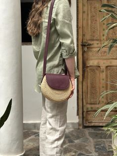 A limited edition style crafted from raffia and full-grain leather that celebrates connection and craftsmanship. This bag was a collaboration between two women-run cooperatives in Marrakech Artisan Bag With Adjustable Strap, Leather Shoulder Bag With Removable Pouch For Vacation, Ethically Sourced Natural Shoulder Bag For Everyday Use, Ethically Sourced Bags For Vacation, Artisan Shoulder Bag In Natural Color, Artisan Shoulder Bag In Natural Color For Everyday Use, Artisan Shoulder Bag With Adjustable Strap For Vacation, Artisan Natural Color Shoulder Bag For Everyday Use, Artisan Style Bag With Removable Pouch