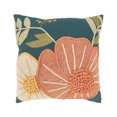 a blue pillow with orange and white flowers on it