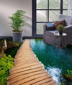 a living room with green water and a wooden walkway leading to a couch in the corner