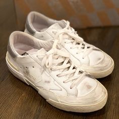 All White (Silver With Logo On Back Of Shoe) Authentic Golden Goose Super Stars. Purchased New And Only Worn A Few Times. Great Condition!!! Comes With Original Box And 2 Original Shoe Bags. Shoe Bags, Golden Goose Shoes, Golden Goose, All White, White Silver, Womens Shoes Sneakers, Women Shoes, White, The Originals