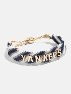 Proudly show off your team loyalty with the New York Yankees MLB Woven Friendship bracelet. This bracelet is crafted with colorful woven thread, which creates a vibrant backdrop for your favorite game day rallying cheer. Secured with an easy pull-tie closure, this spirited and nostalgic accessory will be loved by fellow fans all season long. Please note: due to their handmade nature, each bracelet will be slightly unique. This is an officially licensed MLB product. Adjustable Team Spirit Friendship Bracelets For Game Day, Adjustable Personalized Team Spirit Jewelry, Adjustable White Friendship Bracelets For Game Day, Casual Adjustable Wristband For Game Day, Casual Adjustable Wristband For Fan Merchandise, Team-colored Wristband For Game Day, Adjustable Bracelets For Game Day, Football Season, Casual Personalized Jewelry For Game Day, Yankees Game