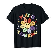 a black t - shirt with the words play is learning written in rainbows and stars