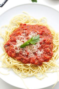 a white plate topped with spaghetti and sauce