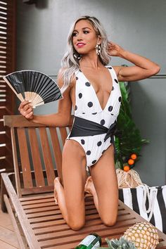 You are sure to be a summer stunner when you wear our flirty white "Aloha Honey" one piece swimsuit featuring stretchy lightweight polyester material patterned with black polka dots, a deep v-cut neckline, 1-inch shoulder straps with a low open back, an accent tie that can be tied in the front or back, and a form fitting silhouette that falls into cheeky fit bottoms! This piece styles perfectly with a cover up, sunnies, and a straw hat and tote for the ultimate swim look! Scalloped One Piece Swimsuit, Fun One Piece Swimsuit, Colorblock Swimsuit, Cut Out One Piece, Floral One Piece Swimsuit, Floral One Piece, Swimsuits Hot, One Piece Swimsuits, Swimsuit Shops