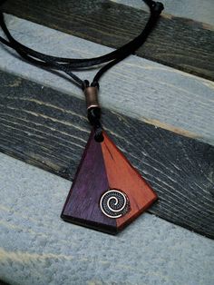 a wooden necklace with a spiral design on it