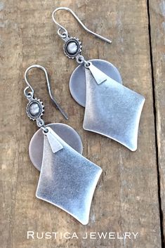 Antiqued silver geometric dangle earrings. #SilverBohoDangleEarrings #SilverGeometricJewelry #AntiquedSilverJewelry #SouthwesternInspiredJewelry #Westernsilverearrings #Bohoearrings #Bohochicjewelry #Giftsforher #Bohobridesmaidgifts #BohoBridejewelry #Silverhandmadejewelry Silver Bohemian Earrings For Everyday, Bohemian Silver Earrings For Everyday, Bohemian Geometric Earrings With Ear Wire, Silver Geometric Pierced Earrings, Southwestern Style Metal Drop Earrings, Nickel Free Silver Southwestern Earrings, Handmade Silver Geometric Earrings, Southwestern Silver Earrings With Oxidized Finish, Bohemian Geometric Nickel-free Jewelry