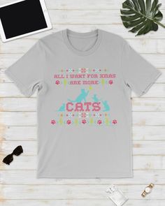 a gray t - shirt that says all i want for christmas is cats on it