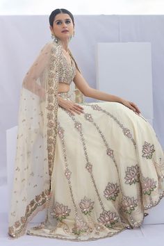 Beige and cream can can attached lehenga with cutdana embellished lotus patterns. Comes with padded embellished blouse and dupatta.
Components: 3
Pattern: Embroidered
Type Of Work: Cutdana,Mirrorwork
Neckline: V-neck
Sleeve Type: Sleeveless
Fabric: Organza,Net
Color: Beige,Cream
Other Details: 
Attached lining
Length:
Blouse: 13 inches
Lehenga: 44 inches
Dupatta: 2.5 mtr
Closure: 
Blouse: Back hook
Lehenga: Side hook
Occasion: Wedding,Bride - Aza Fashions Bridal Lehengas, Embellished Blouse, Set Women, Bridal Lehenga, Set For Women, Aza Fashion, Sleeve Type, Wedding Bride, Lehenga