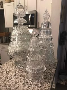 three glass dishes sitting on top of a kitchen counter