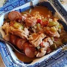 a blue and white bowl filled with food on top of a table